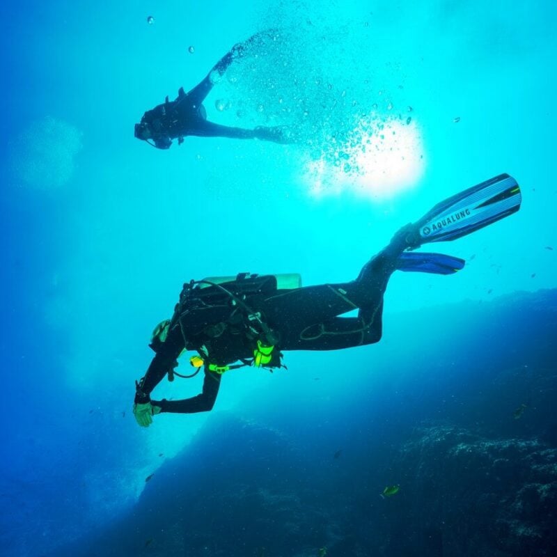 photography of two persons underwater